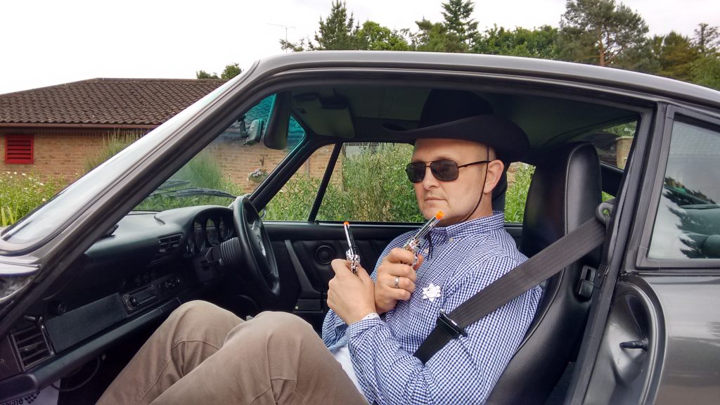 John 'Birchy' Birch fulfilling his wish of dressing as a cowboy riding in a Porsche