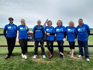 Group of supporters wearing St Nic's T-shirts, about to do a skydive