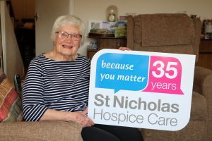 Joyce Norburn, wife of the late Rev Canon Richard Norburn, holds the 35 year St Nicholas Hospice Care logo