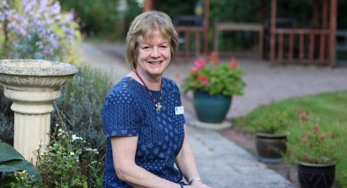 hospice trustee marion miles sitting in the hospice garden