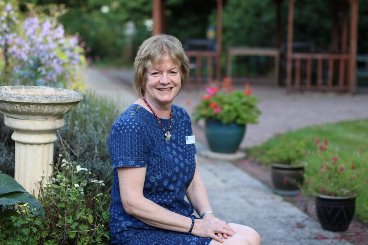 hospice trustee marion miles sitting in the hospice garden