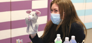 psychological services team member with puppet and paints