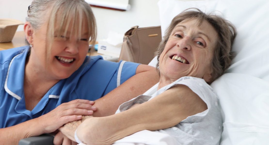 hospice patient and nurse smiling