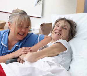 hospice patient and nurse smiling