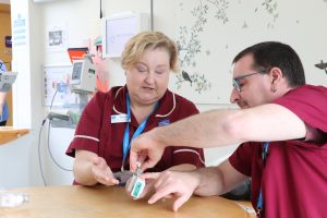 hospice staff looking at a syringe driver