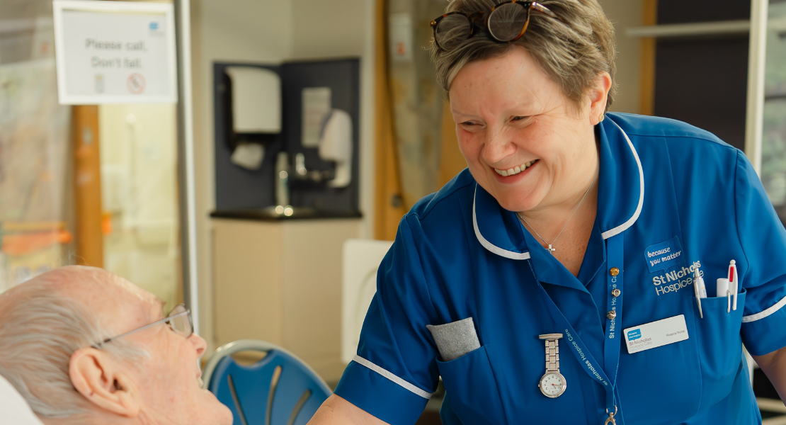 Photo of a hospice nurse smiling at a patient