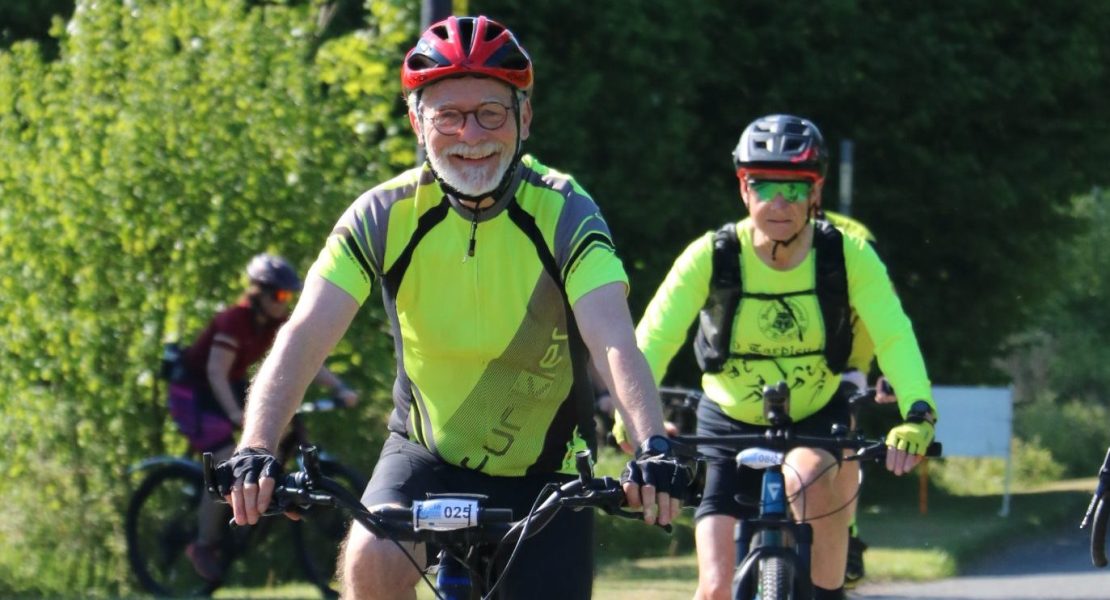 Smiling cyclist taking part in the St Nic's Cycle Ride