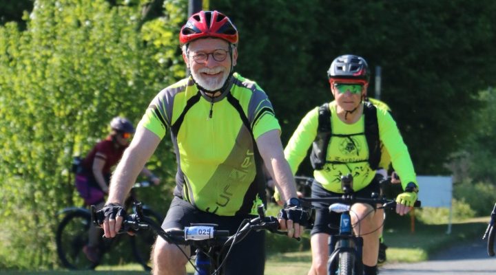 Smiling cyclist taking part in the St Nic's Cycle Ride
