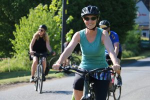 Smiling cyclist taking part in the St Nic's Cycle Ride