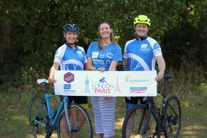 St Nicholas Hospice Care staff in cycling jerseys standing by their bikes