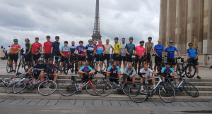 Group photo of London to Paris Bike Ride participants, near the Eiffel Tower