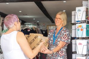 Donations being received at a hospice shop