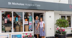 Staff in the doorway of the Hospice's Long Melford shop