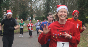 smiling runners wearing Christmas attire