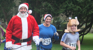 Smiling runners dressed in Christmas attire and Santa suits