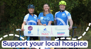 Hospice cyclists holding a London to Paris Bike Ride banner with the words 'Support your local hospice'