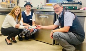 Chassis Cab presenting a new dishwasher to Hospice staff
