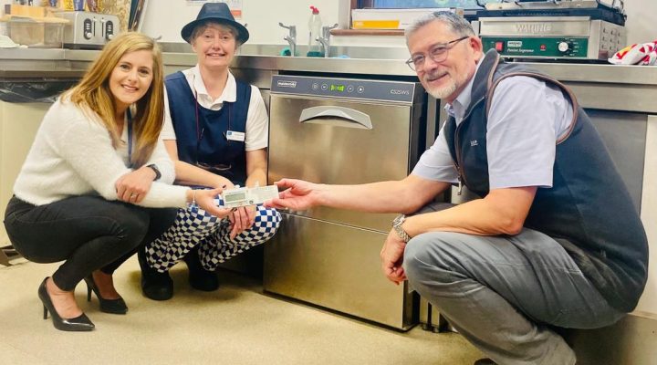 Chassis Cab presenting a new dishwasher to Hospice staff