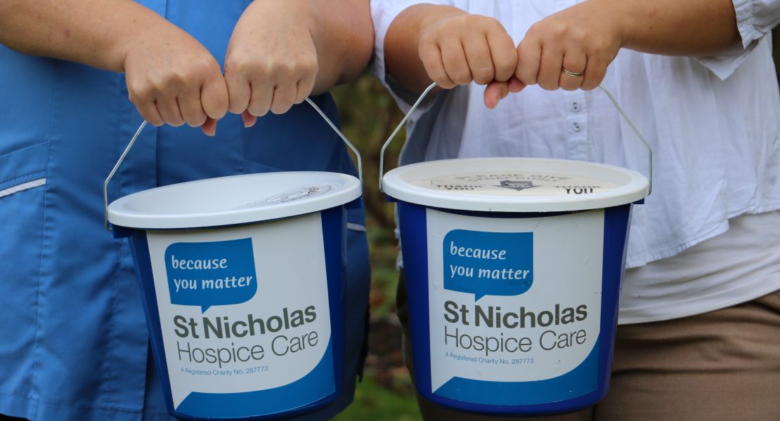 Collection buckets being held out