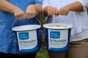 Collection buckets being held out