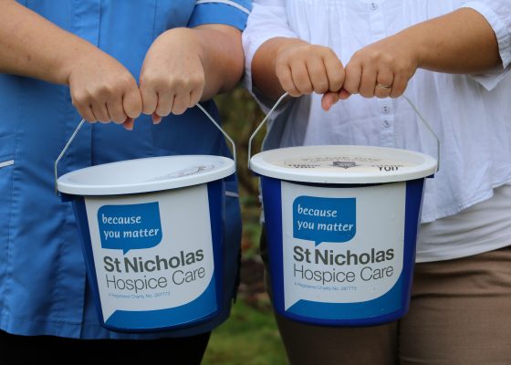 Collection buckets being held out