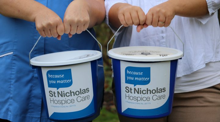 Collection buckets being held out