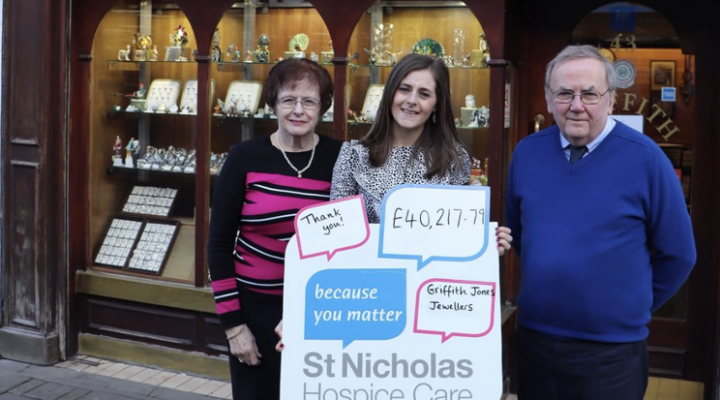 Griffin Jones Jewellers staff alongside Hospice Corporate Fundraiser holding a Hospice sign
