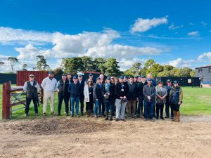 A corporate team wearing hard hats assembled for a Hospice fundraising event