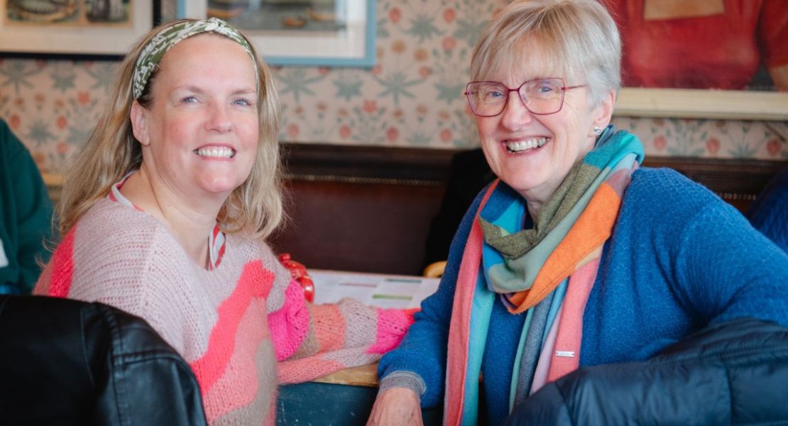 Two Hospice Neighbours volunteers chatting and smiling