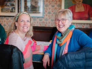 Two Hospice Neighbours volunteers chatting and smiling