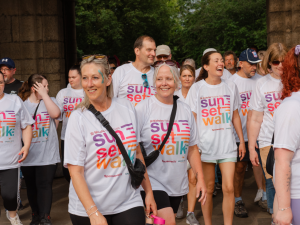 A group of smiling Sunset Walk participants