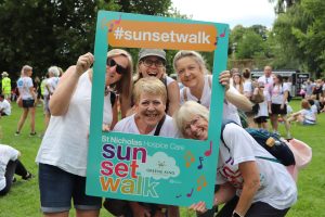 Sunset Walk participants smiling through the selfie frame