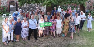 Image of those who took part in 2026's Hidden Gardens of Bury at a thank you event. Group of people looking at the camera and smiling
