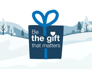 Illustration of a wrapped gift with the text “Be the gift that matters” against a winter landscape background.